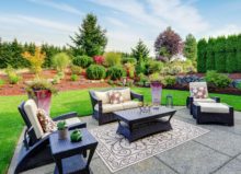 Impressive backyard landscape design with patio area