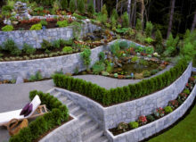 A stone retaining wall in a landscaped garden