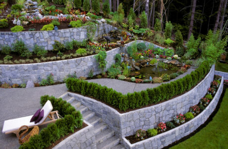 A stone retaining wall in a landscaped garden