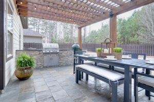 Outdoor kitchen with grill and patio furniture