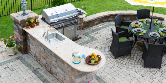 Outdoor stone kitchen with grill and patio